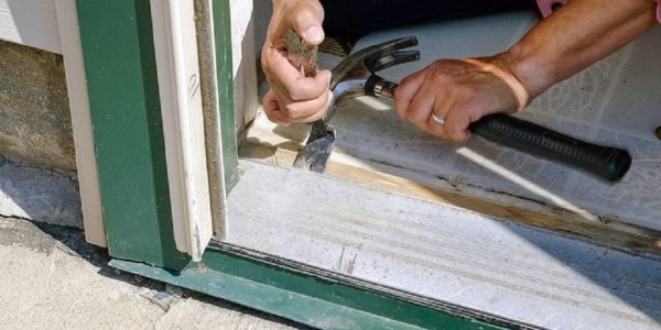 How long should I wait before hanging the door after frame installation