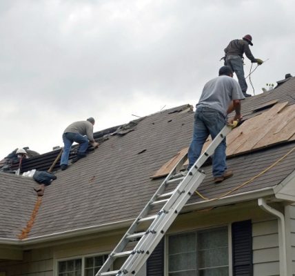 Roof contractors repairing hail damage quickly on a residential roof near me