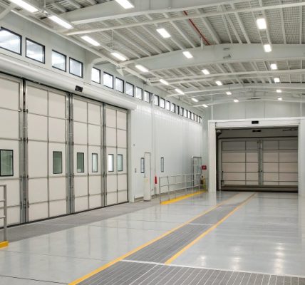 A spacious 120-foot-wide industrial paint booth designed for coating large railings and panels, showcasing its size and suitability for heavy-duty painting projects.