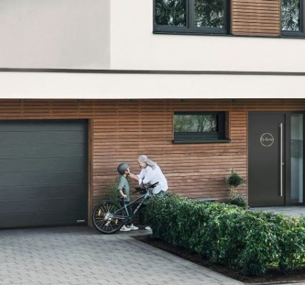 Modern garage door designs 2025 in the UK featuring sleek wood and smart automation