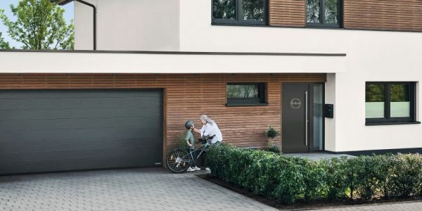 Modern garage door designs 2025 in the UK featuring sleek wood and smart automation
