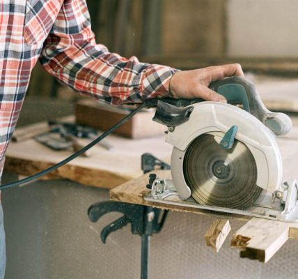 Close-up of a 5 1 2 inch circular saw mid-cut on plywood, showcasing clean edges and compact design for home DIY.