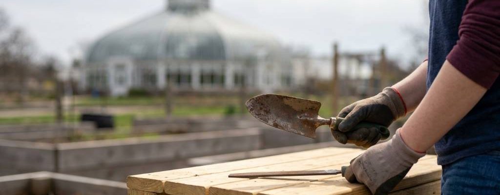 Beginner sharpening a garden hoe with a hand file